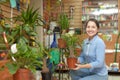 Happy mature woman with Nolina plant