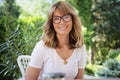 Happy mature woman relaxing at the backyard at home Royalty Free Stock Photo