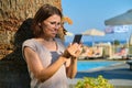 Happy mature woman with smartphone. Female resting in resort spa hotel Royalty Free Stock Photo