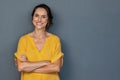 Happy mature woman smiling on grey wall Royalty Free Stock Photo