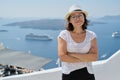 Happy mature woman tourist traveling on famous island Santorini