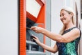 Happy mature woman withdraw money from bank cash machine with debit card - Senior female doing payment with credit card in ATM Royalty Free Stock Photo