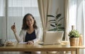 Happy mature woman working online, checking email laptop computer while sitting in bright living room Royalty Free Stock Photo