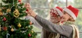 Senior man and woman decorating Christmas tree Royalty Free Stock Photo
