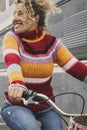 Happy mature young woman riding a bike and smiling enjoying outdoor active healthy leisure activity. Green ambien and environment Royalty Free Stock Photo