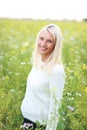 Happy matured woman in flowerfield