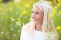 Happy matured woman in flowerfield