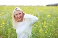 Happy matured woman in flowerfield