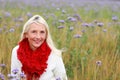 Happy matured woman in flowerfield