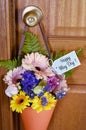 Happy May Day gift of flowers on door. Royalty Free Stock Photo