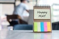 Happy May with note paper reminder template with pen on wooden table. Copy space for your text