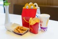 Happy Meal menu at McDonald`s restaurant. Happy Meal Kids Next to Cheeseburger, Drink and Chicken McNuggets. Time for a snack,