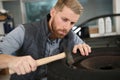 happy mechanic fixing car tire at repair shop Royalty Free Stock Photo