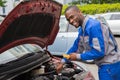 Mechanic Using Multimeter To Check Car Battery Royalty Free Stock Photo