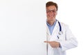 Happy medical doctor pointing at blank sign