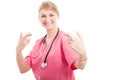 Happy medical female nurse making fingers crossed gesture