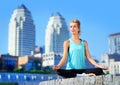 Happy meditating woman sitting in siddhasana