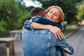 Happy meeting of two lovers hugging in the street