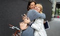 Happy meeting of two women friends hugging in the street Royalty Free Stock Photo