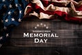 Happy Memorial Day. American flags with the text REMEMBER & HONOR against a old wooden background. May 25