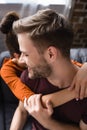 Man embraced by tender girlfriend at