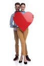 Happy couple holding a big red heart Royalty Free Stock Photo