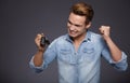 Happy men holding out car keys. Royalty Free Stock Photo