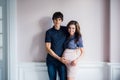 A happy man is lovingly holding his pregnant wife belly. Royalty Free Stock Photo