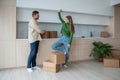 Happy tired young family couple talking on kitchen among boxes moving to new apartment daydreaming. Royalty Free Stock Photo