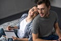 Happy man and woman in glasses writing in notepad while lying Royalty Free Stock Photo