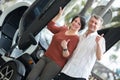 Couple standing near twizy electric