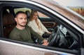 Happy couple man and woman traveling in car