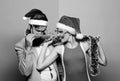 Happy man and woman wear santa hats and funny sunglasses. Cheerful couple celebrate new year. Corporate holiday party Royalty Free Stock Photo