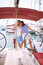 Man and woman on yacht at wheel going on ocean trip. Summer holiday Royalty Free Stock Photo