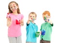 Happy messy kids with paint brushes Royalty Free Stock Photo