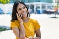 Happy mexican young adult woman talking with boyfriend at phone Royalty Free Stock Photo