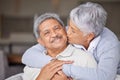 Happy Mexico senior couple kiss on living room sofa for love, care and trust in romantic relationship at house or home Royalty Free Stock Photo