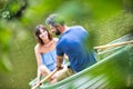 Tilt shot of happy mid adult couple boating in lake during summer