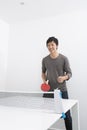 Happy mid adult man playing ping pong Royalty Free Stock Photo