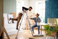 Mid adults couple having fun when painting indoors at home, relocation and diy concept. Royalty Free Stock Photo