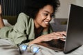 Happy young african woman using laptop computer Royalty Free Stock Photo