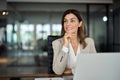 Happy mid aged professional business woman working in office looking away. Royalty Free Stock Photo