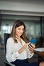 Happy mid aged 40s business woman holding phone using cellphone in office. Royalty Free Stock Photo