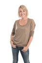 Happy middle age blond woman in blue jeans isolated over white. Royalty Free Stock Photo