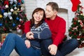 Happy Middle Age Couple In Christmas Fire Place In Home, New Year Celebration