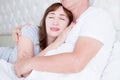 Happy middle age family couple in bed. White interior. Love and healthy relationships. Husband and wife portrait. Cropped image