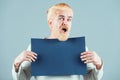 Happy middle age man presenting empty paper. Male model holding white board. Blank, empty paper, billboard with copy Royalty Free Stock Photo