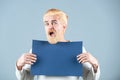 Happy middle age man presenting empty paper. Male model holding white board. Blank, empty paper, billboard with copy Royalty Free Stock Photo