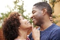 Happy middle aged African American couple embracing outdoors, side view,close up