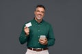 Happy middle aged business man holding mobile phone and credit card mockup. Royalty Free Stock Photo